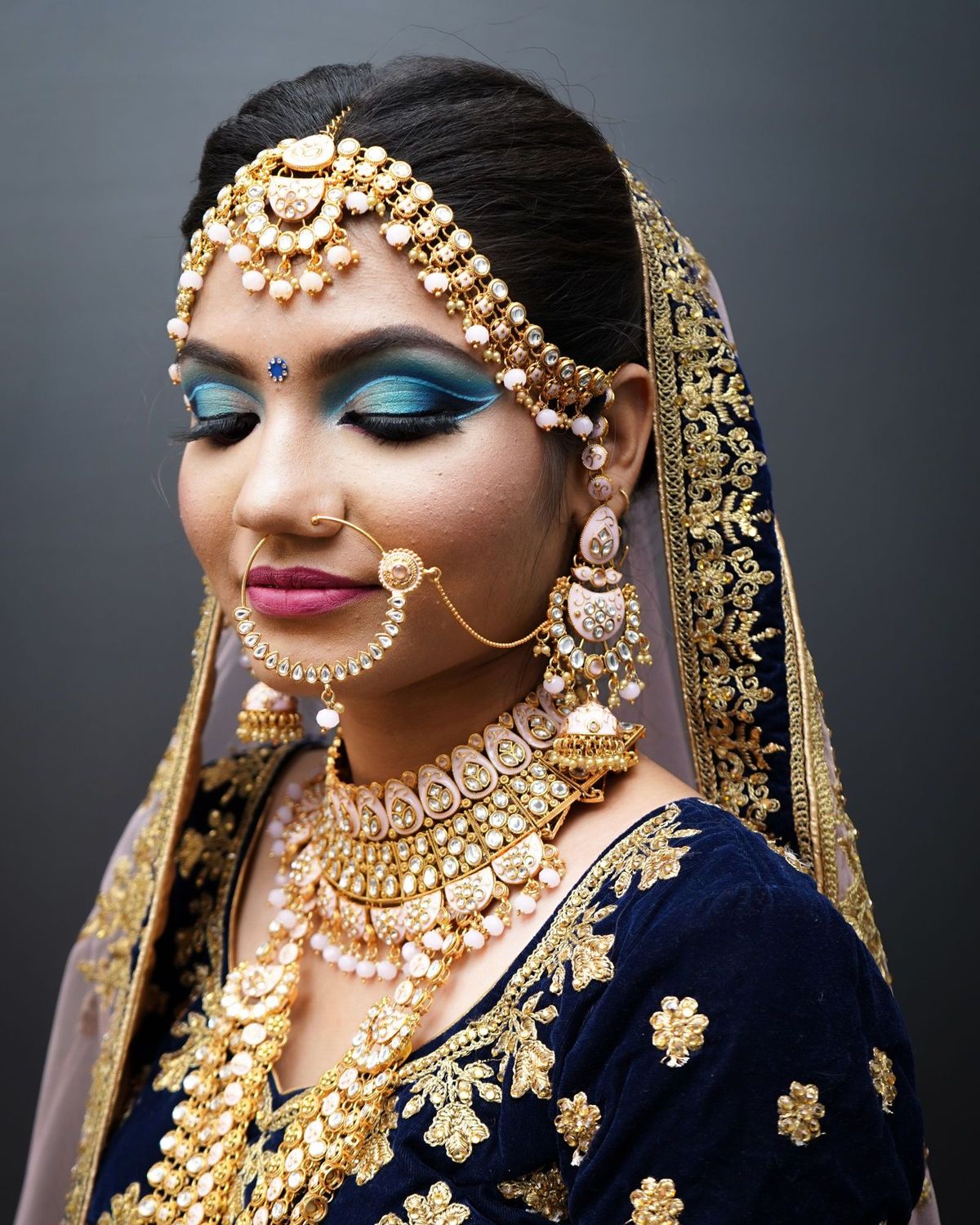 Bride with full bridal makeup and traditional gold jewellery