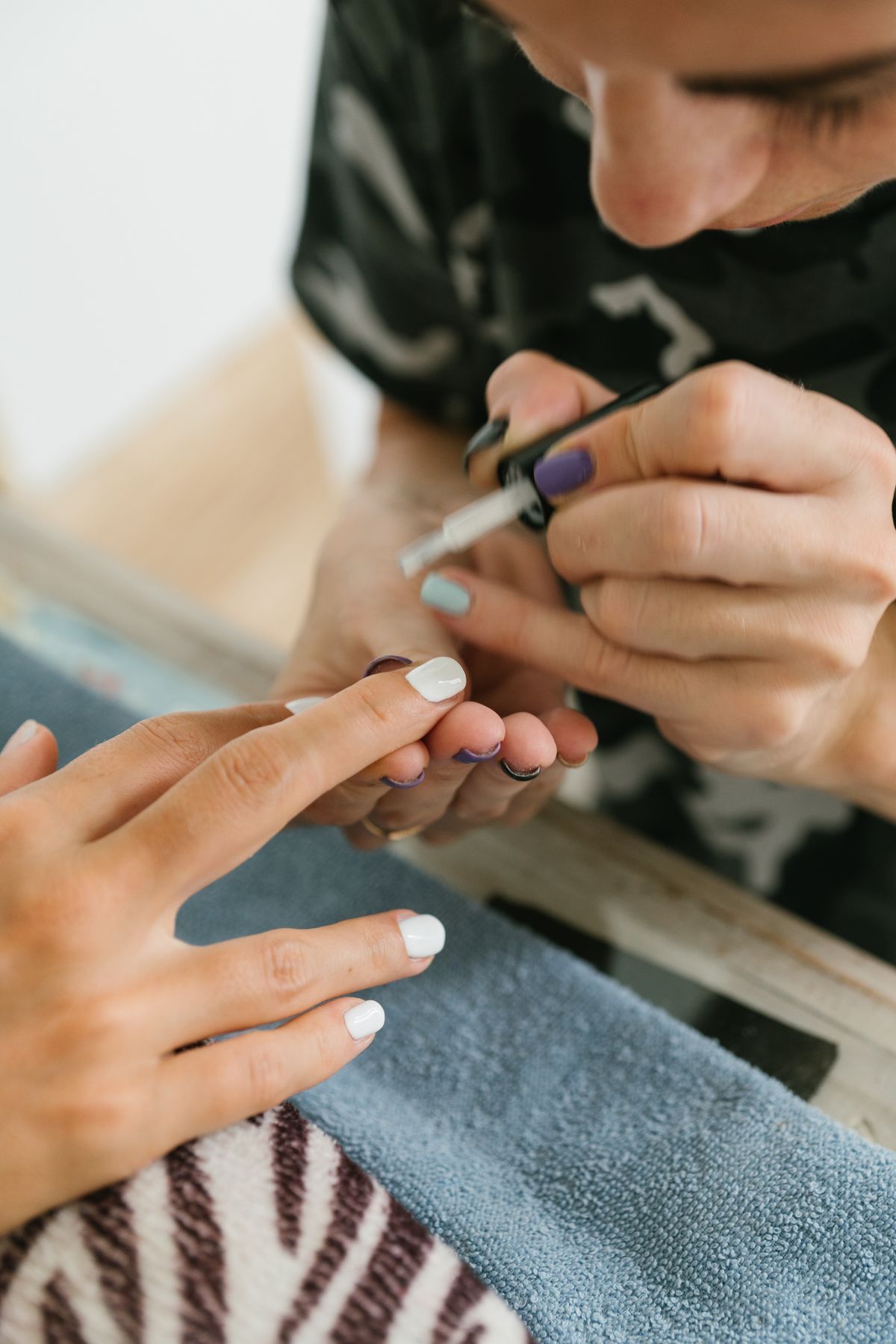 Manicure with detailed nail art being painted