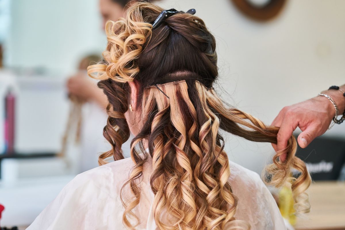 Hair being curled and finished in a salon